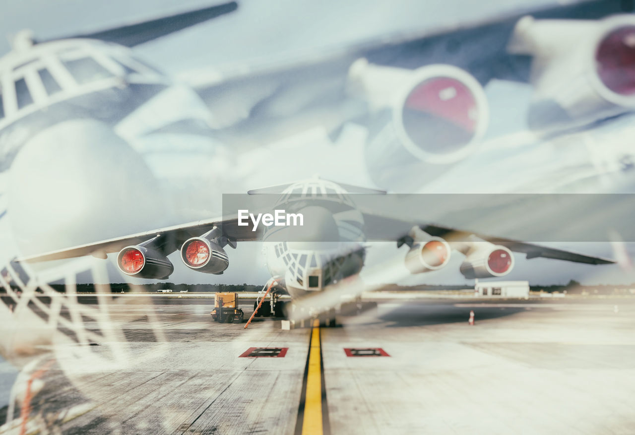 Airplane on airport runway against sky