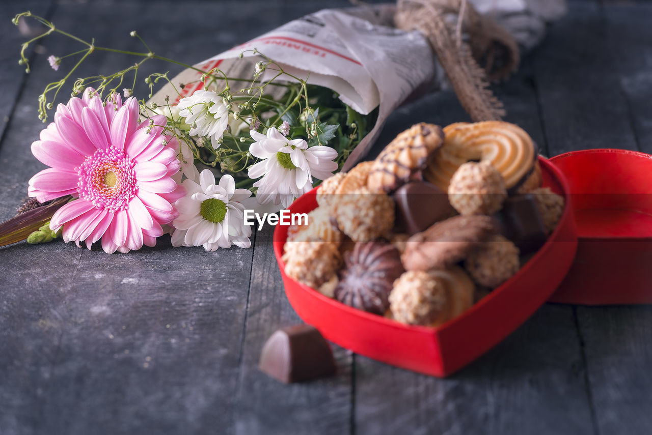 Close-up of cookies and bouquet on table