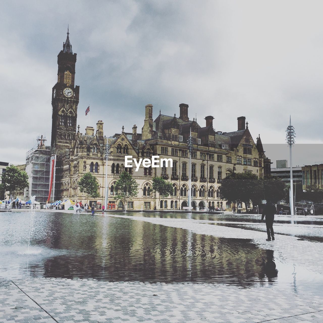 Clock tower in bradford city park against cloudy sky