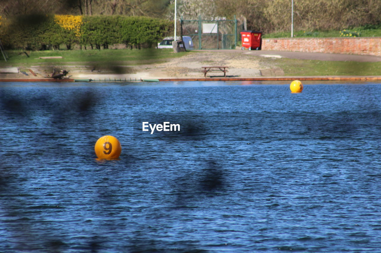 Yellow ball floating on lake 