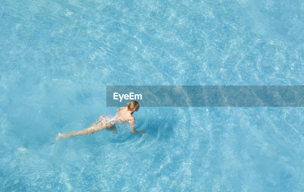 High angle view of woman swimming in sea