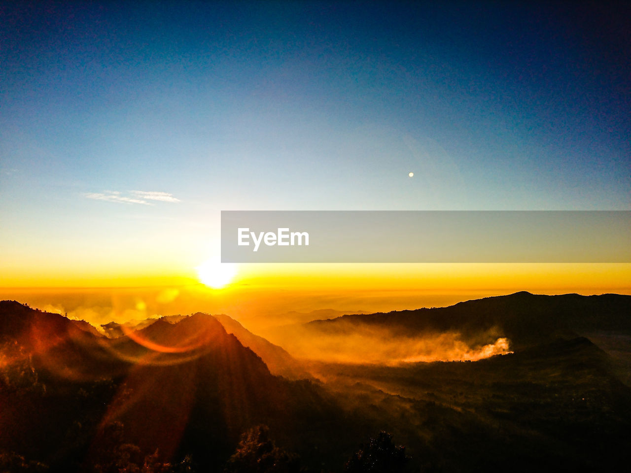 Scenic view of mountains against sky during sunset