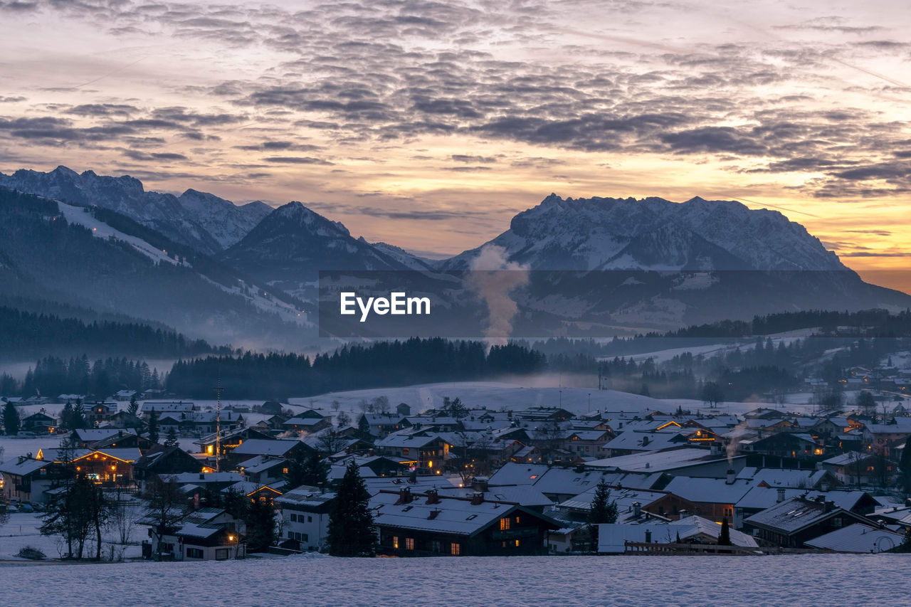 Scenic view of snowcapped mountains against sky during sunset