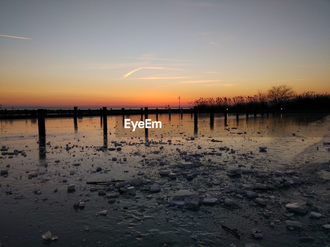 Scenic view of beach against sky during sunset