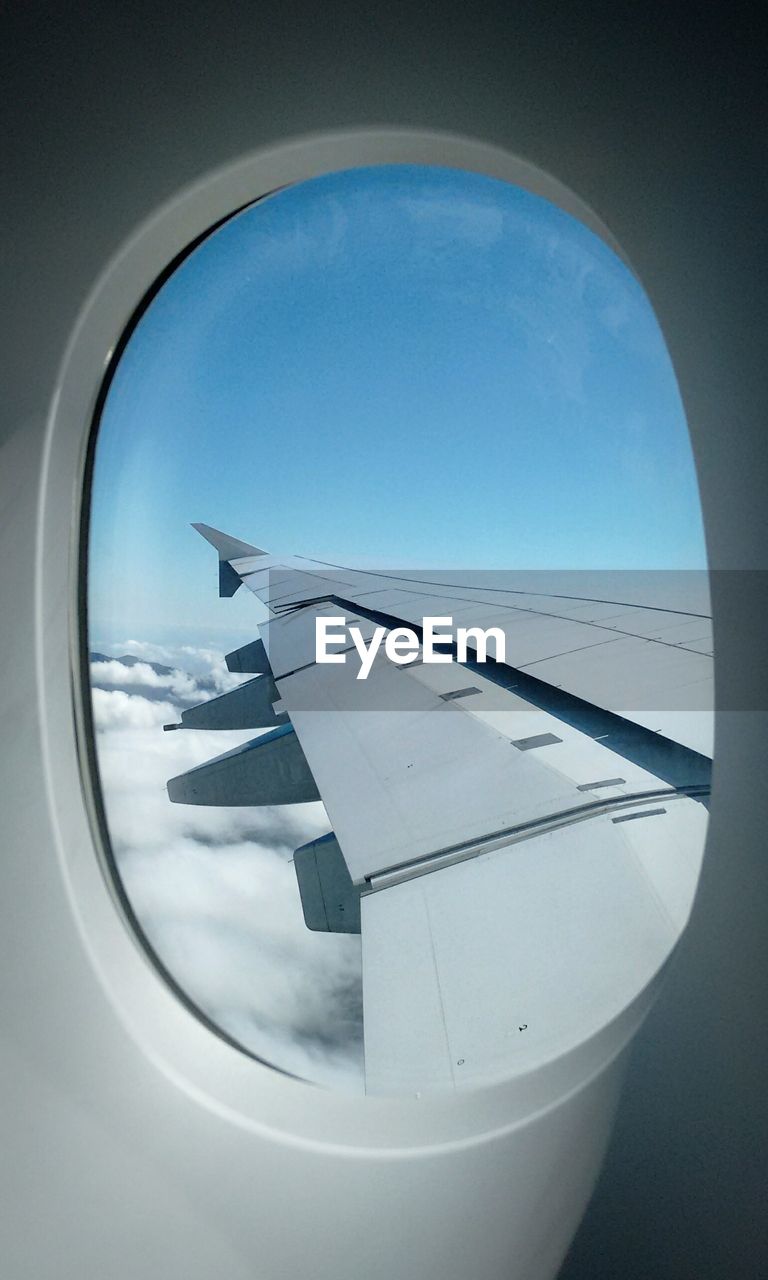 AIRPLANE WING SEEN THROUGH WINDOW