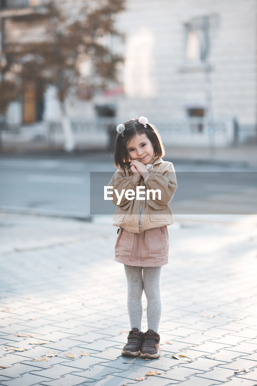 Cute girl standing on street