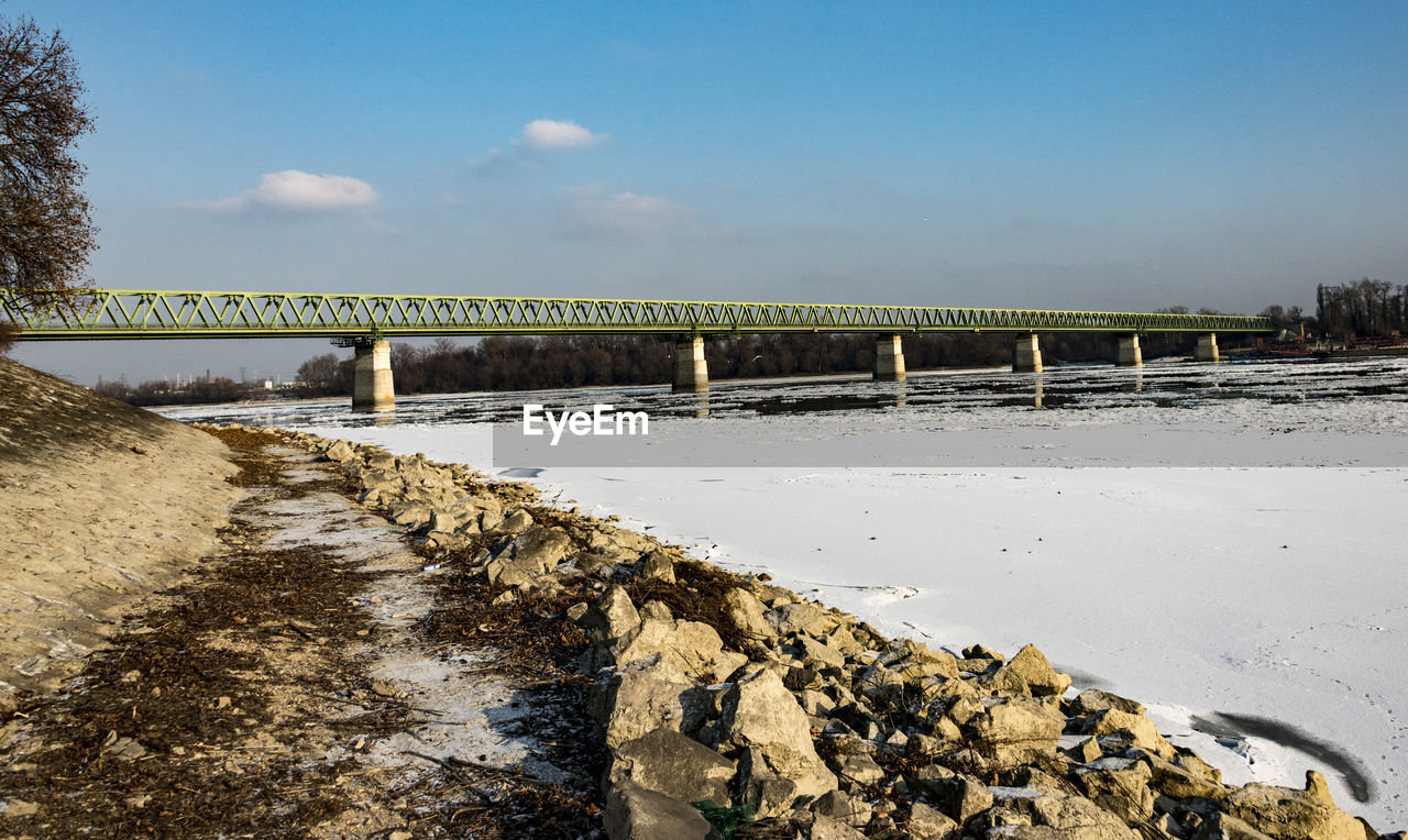 Scenic view of beach against sky during winter