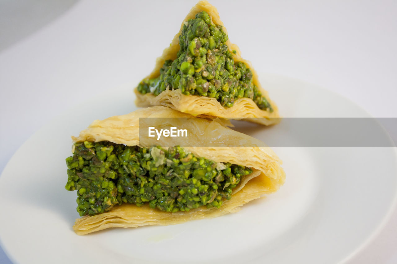 Close-up of food in plate over white background