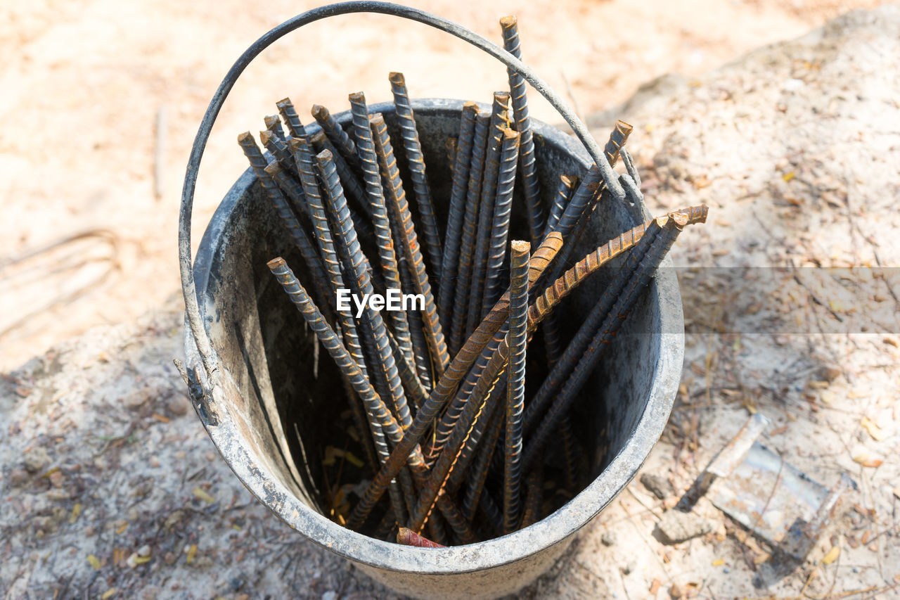 High angle view of metal rods in bucket