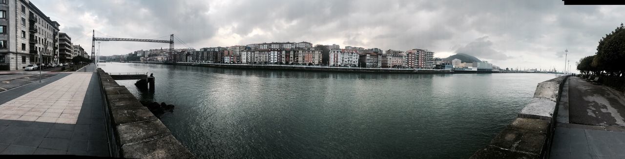 Panoramic view of city against cloudy sky