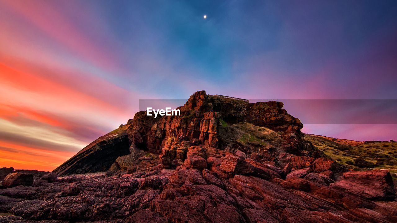 Scenic view of rocky mountains against sky during sunset