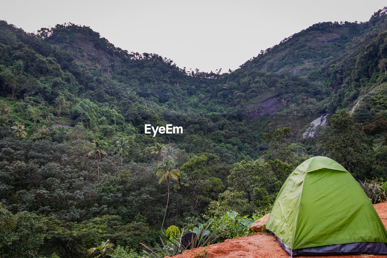 Solo traveller camping experience is expressed with his bike and tent