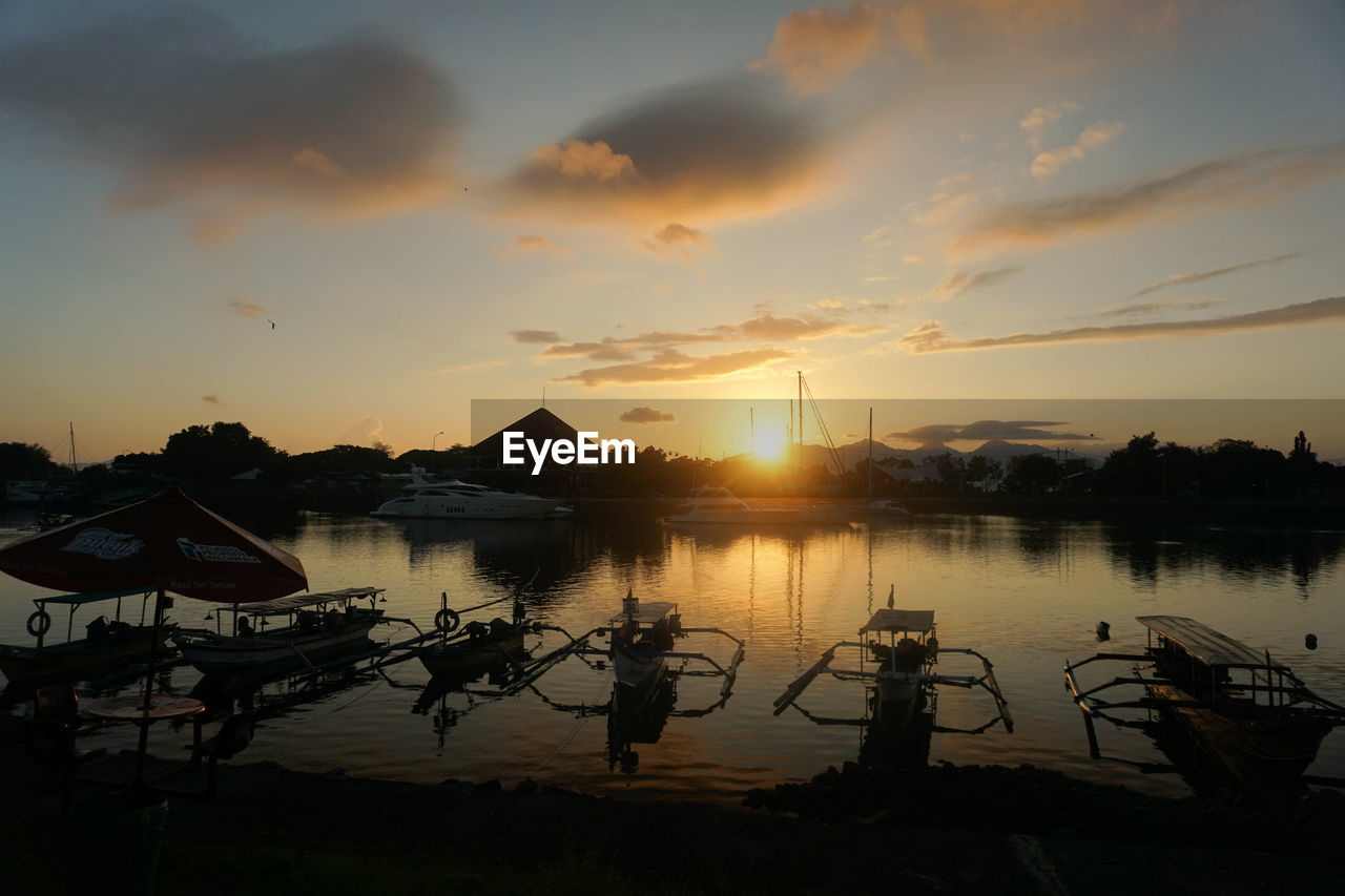 water, sky, sunset, nature, cloud, beauty in nature, evening, tranquility, dusk, reflection, scenics - nature, sea, silhouette, tranquil scene, architecture, nautical vessel, sun, transportation, beach, outdoors, no people, travel destinations, mode of transportation, sunlight, idyllic, land, afterglow, travel, built structure, environment, pier, landscape