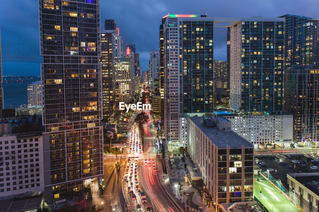 High angle view of illuminated cityscape against sky at night