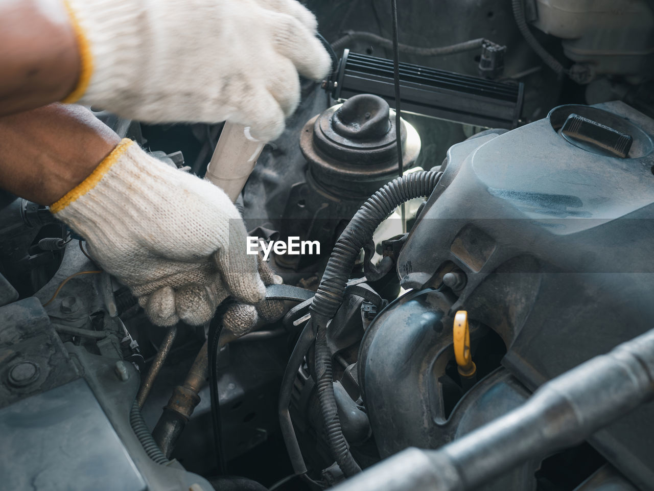 midsection of man repairing car