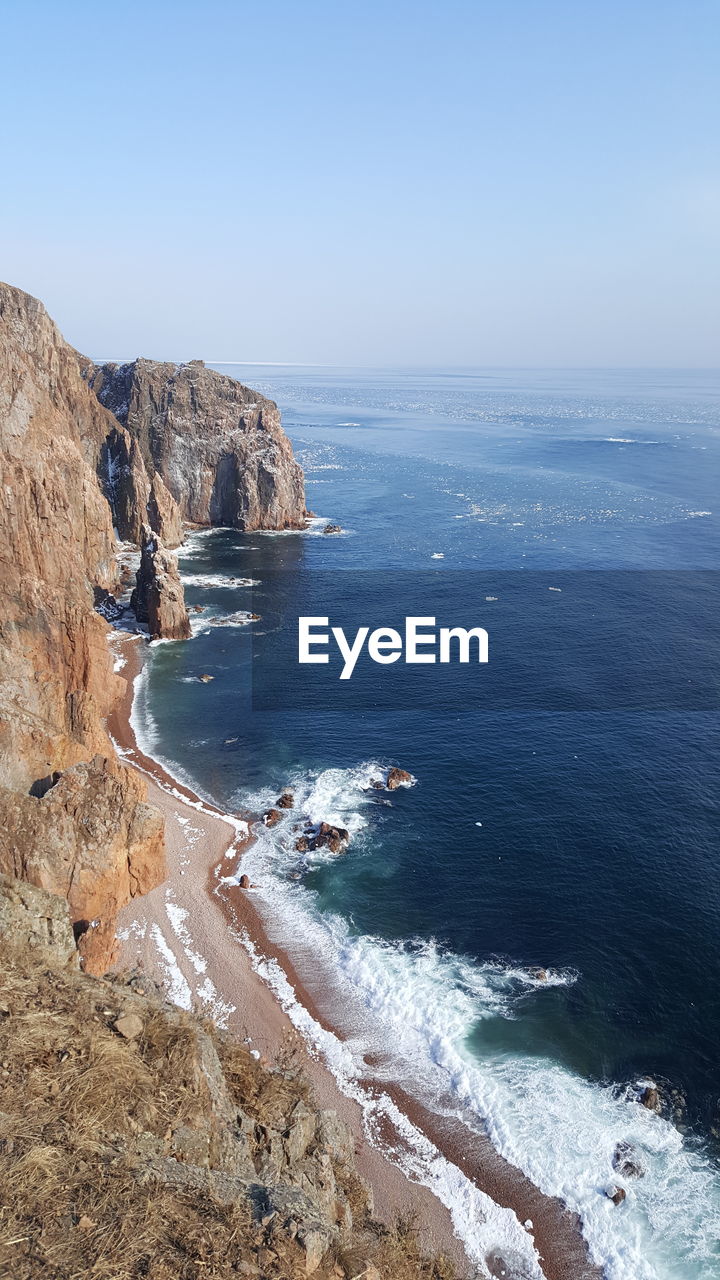 Scenic view of sea against blue sky