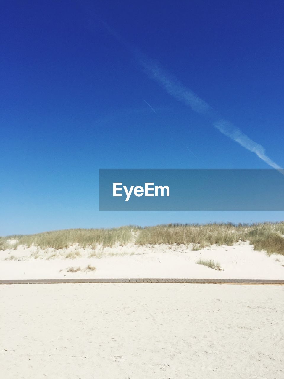 SCENIC VIEW OF BEACH AGAINST BLUE SKY