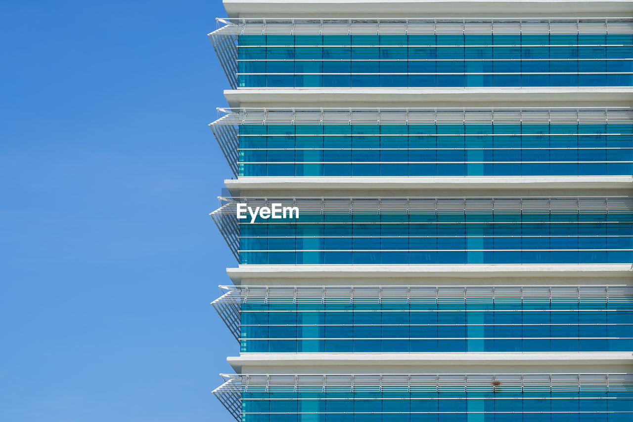 LOW ANGLE VIEW OF BUILDING AGAINST BLUE SKY