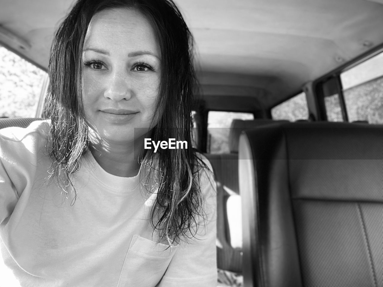 Portrait of smiling young woman in car