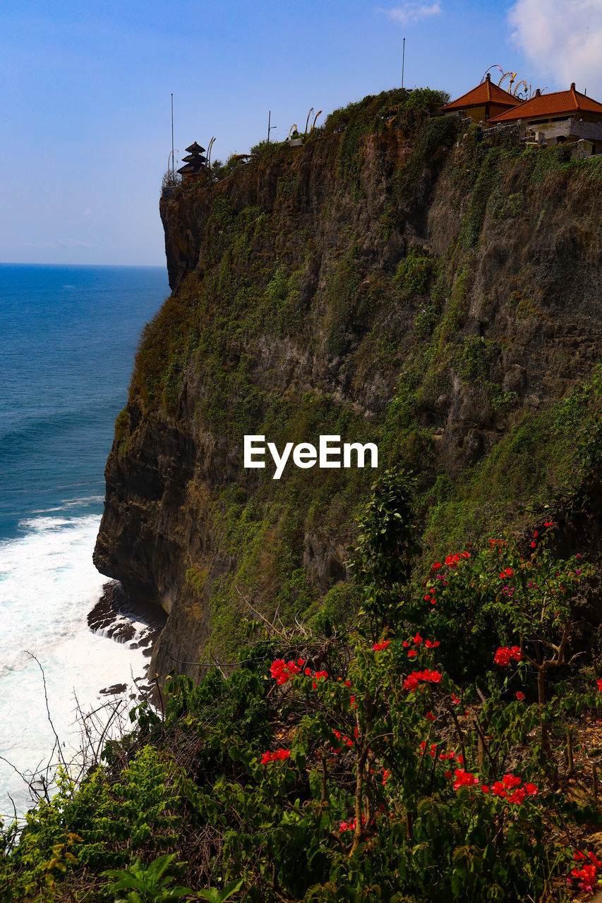 sea, water, cliff, land, coast, beach, sky, nature, beauty in nature, scenics - nature, terrain, coastline, rock, travel destinations, plant, shore, ocean, travel, environment, landscape, no people, tourism, mountain, horizon over water, holiday, architecture, outdoors, tranquility, flower, trip, tranquil scene, horizon, non-urban scene, vacation, body of water, rock formation, building, cloud, day, lighthouse, flowering plant, built structure, idyllic, seascape, clear sky, coastal feature, island, tower, wave, building exterior