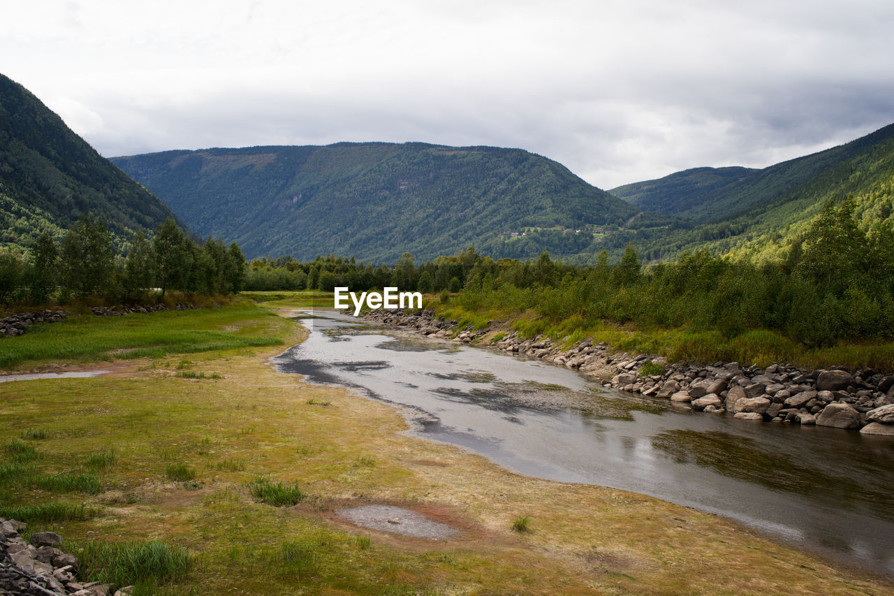 Scenic view of river flowing through mountains