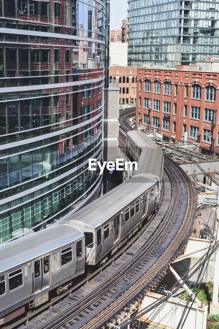 High angle view of railroad tracks amidst buildings in city