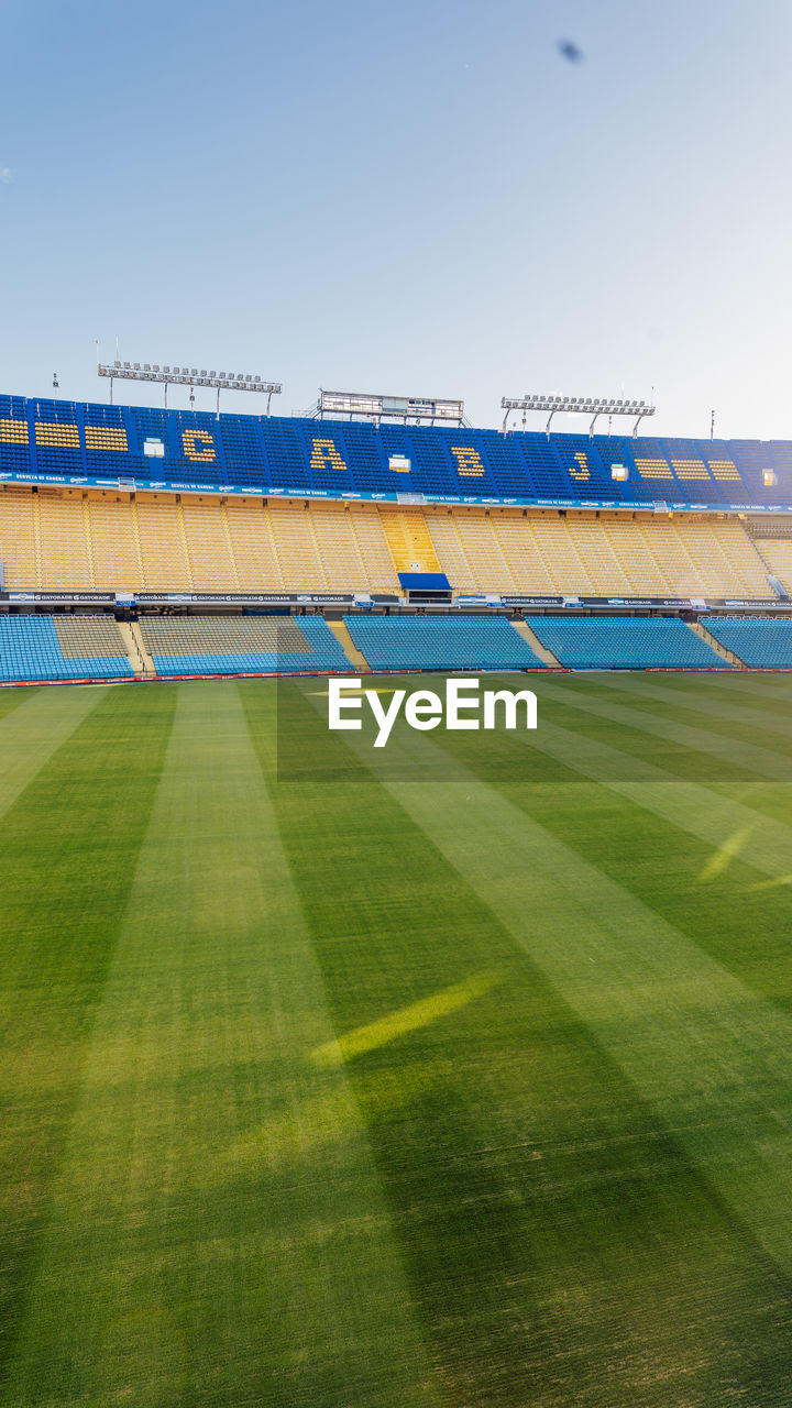 LOW ANGLE VIEW OF SOCCER FIELD AGAINST CLEAR BLUE SKY