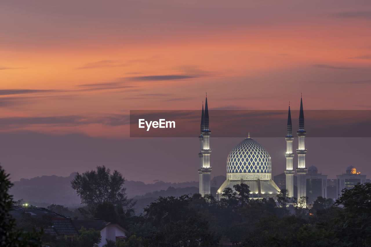 TRADITIONAL BUILDING AGAINST SKY AT SUNSET