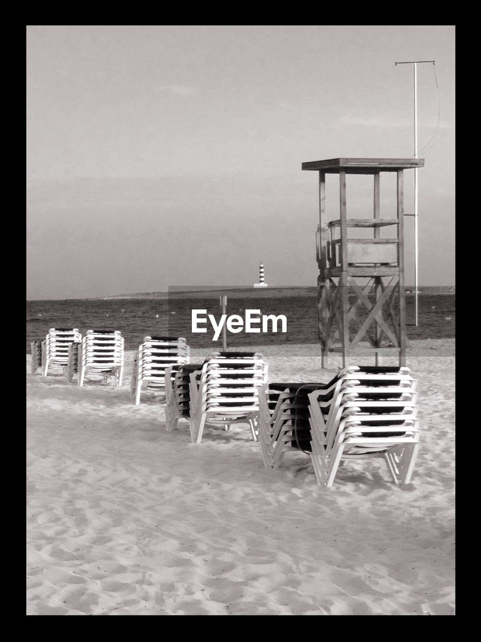 Chairs at beach against sky