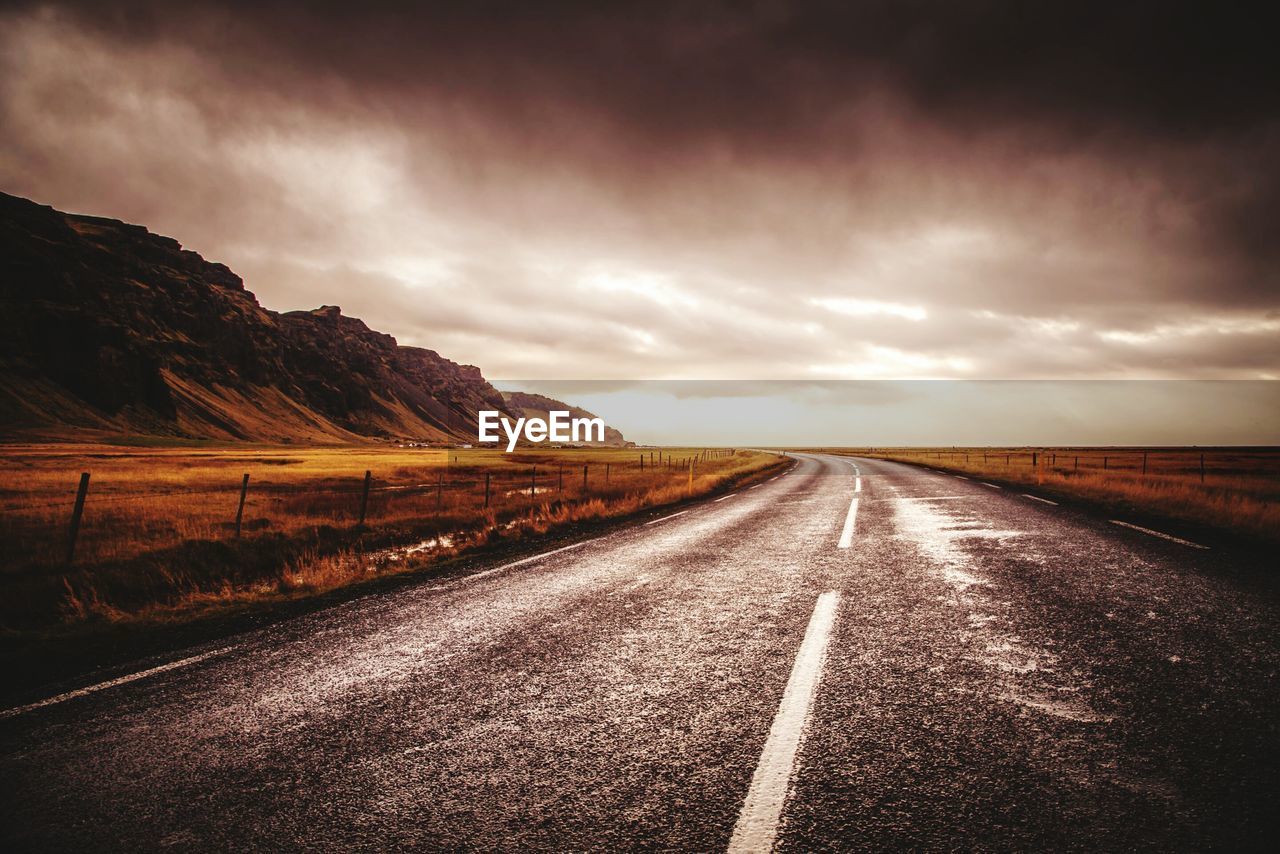 Road amidst landscape against sky