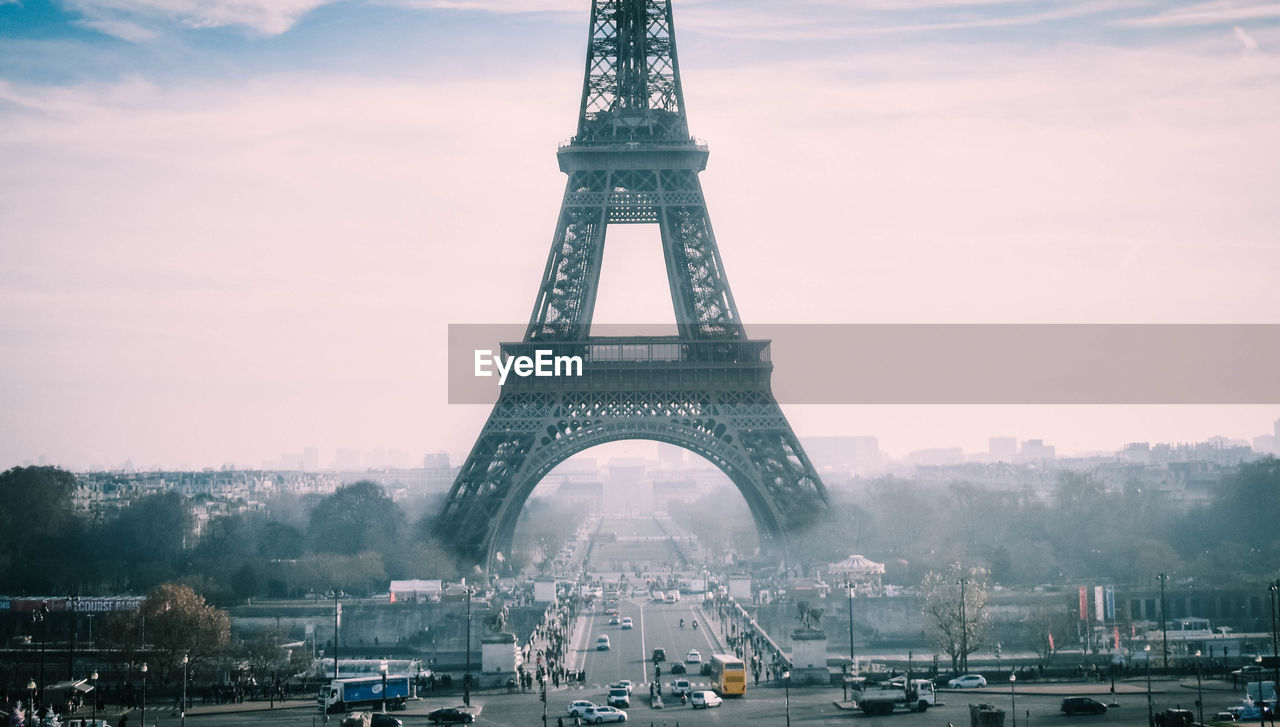 Eiffel tower during foggy weather against sky