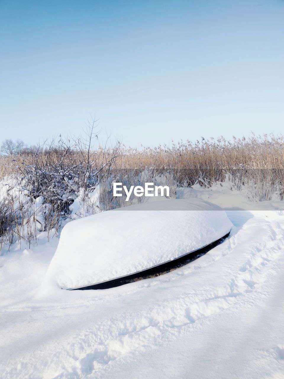 Snow covered field against sky