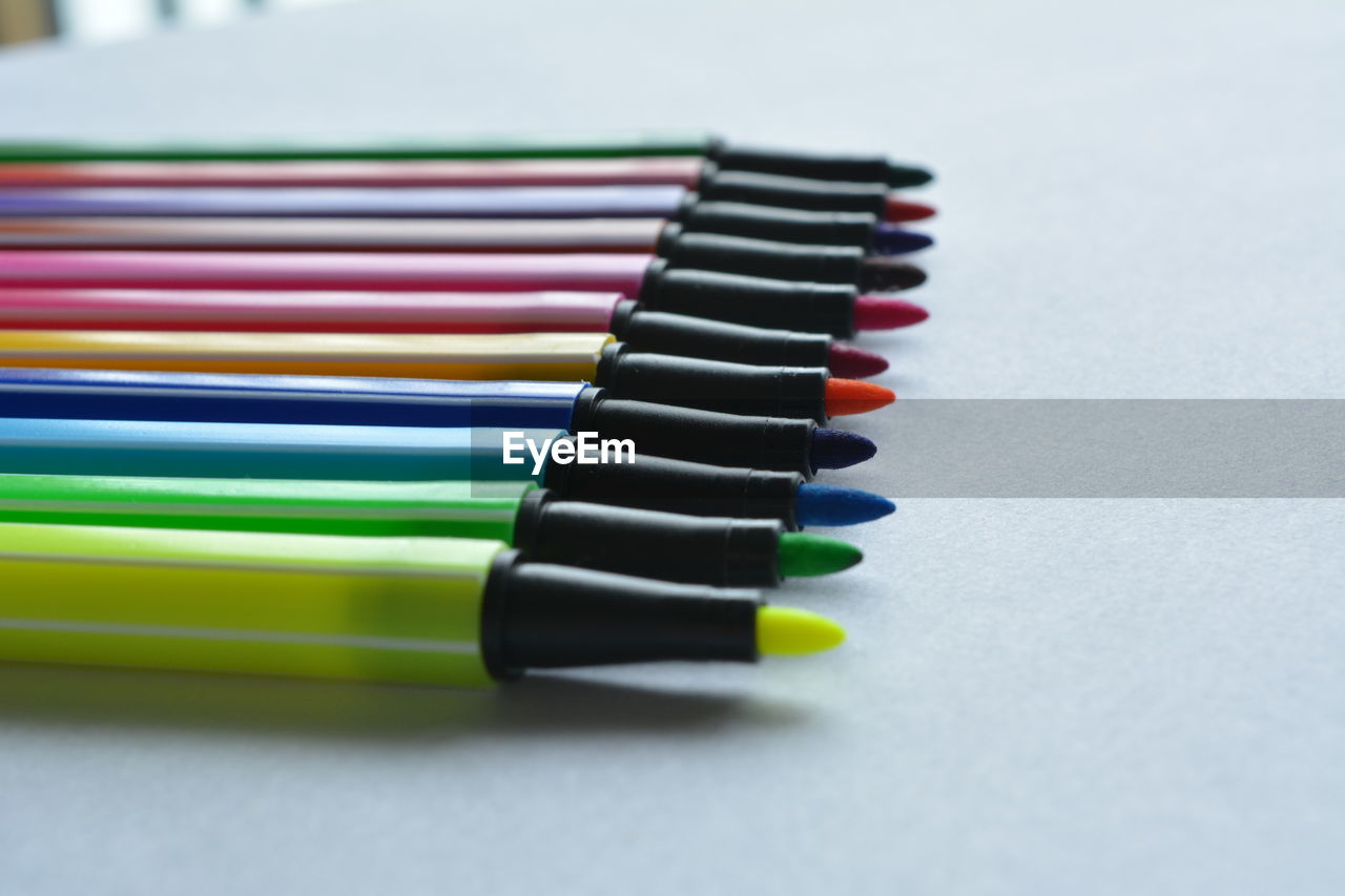 Close-up of colored pencils against white background