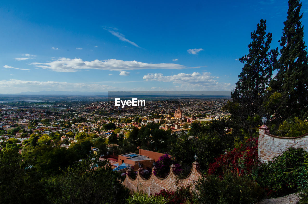 High angle view of cityscape against blue sky