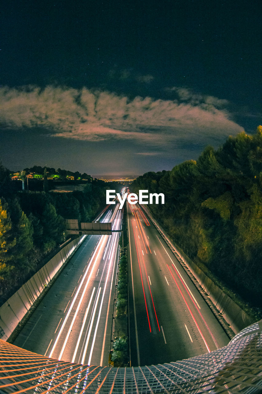 HIGH ANGLE VIEW OF LIGHT TRAILS ON ROAD