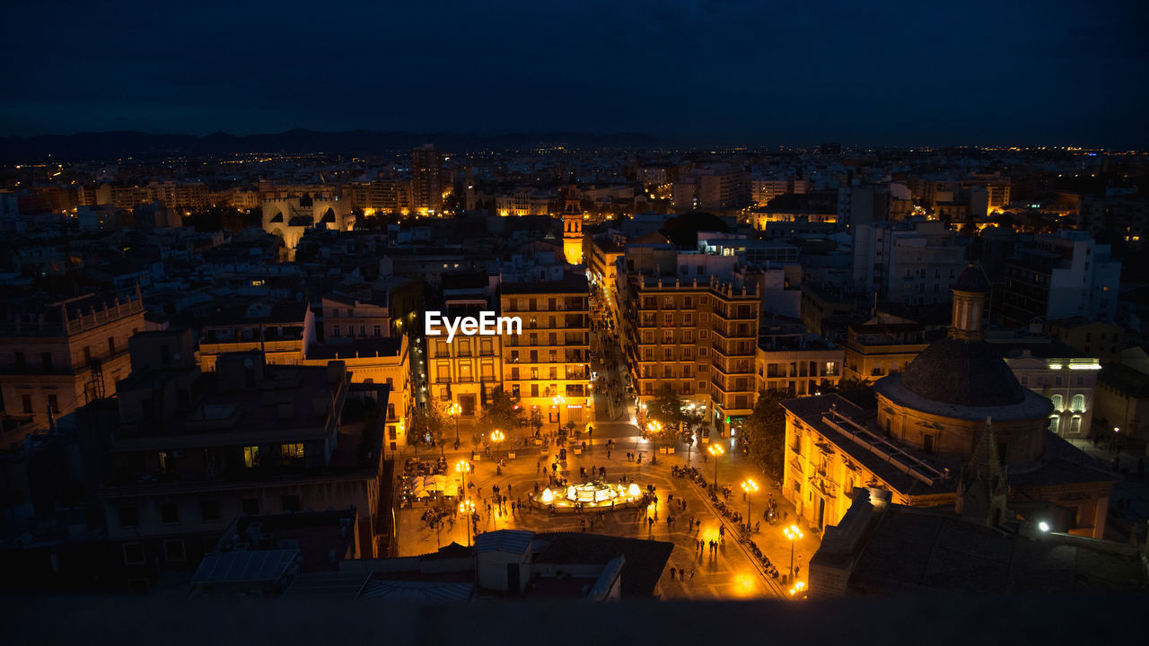 High angle view of illuminated buildings in city at night