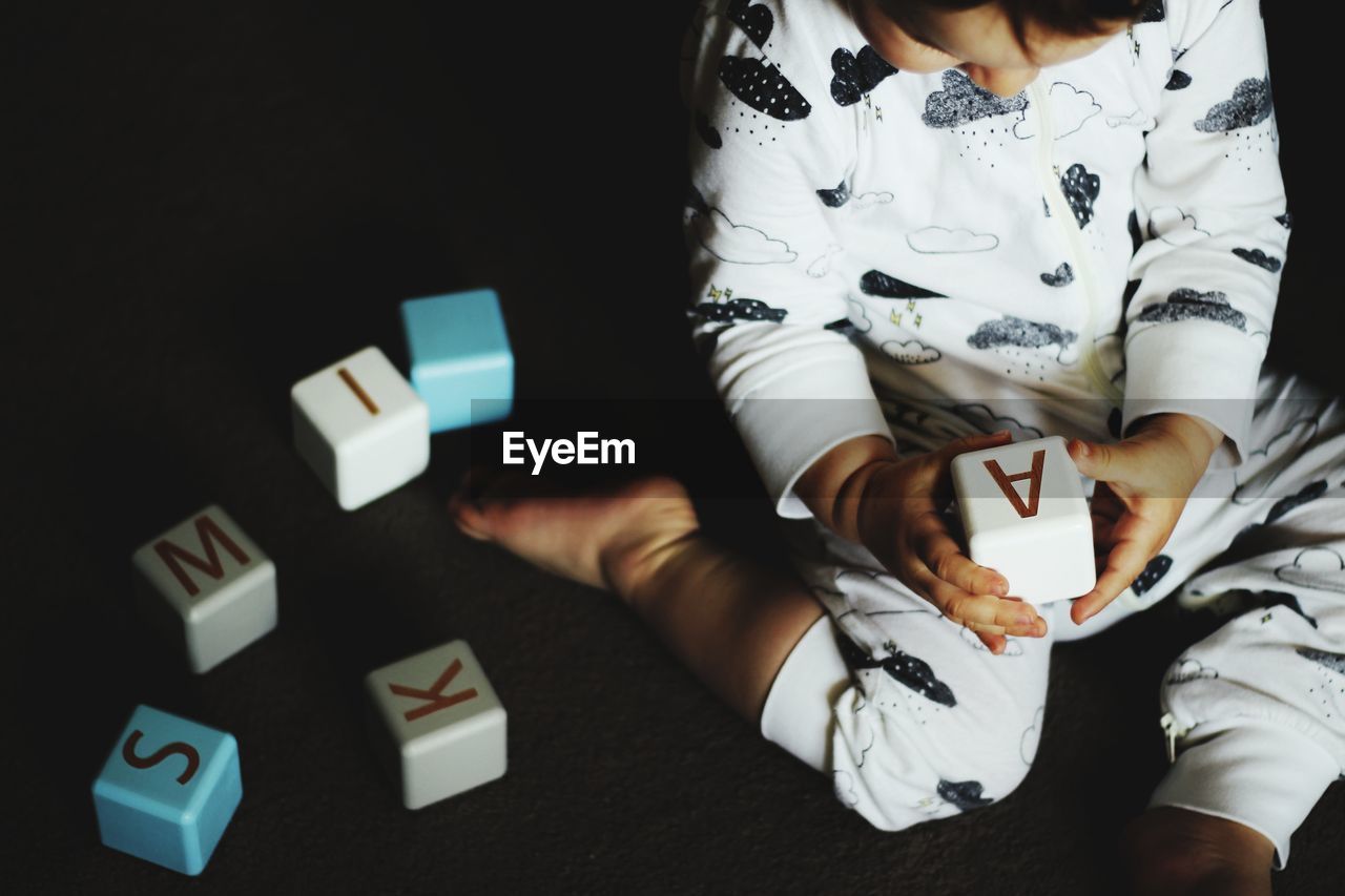 Close-up of young boy playing with blocks