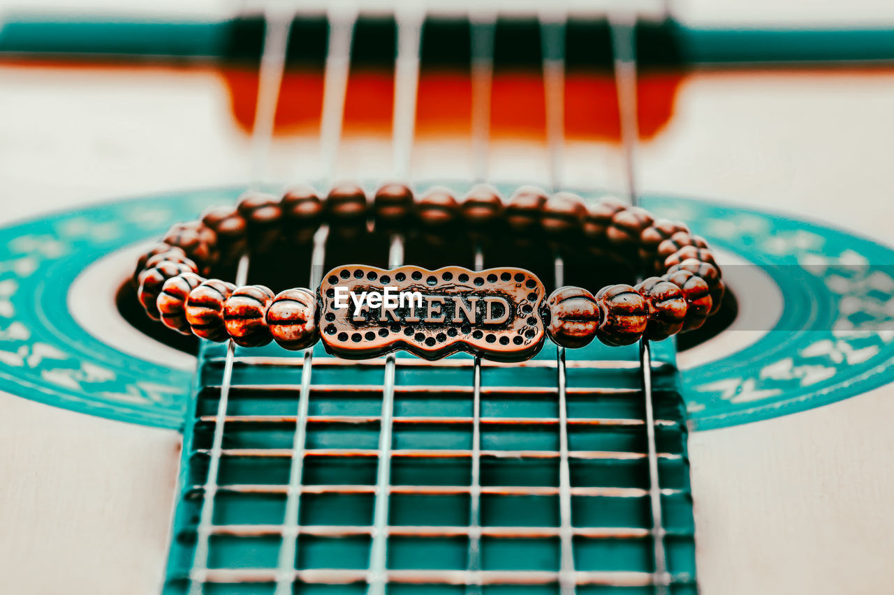 Close-up of a bracelet with a friend text on it