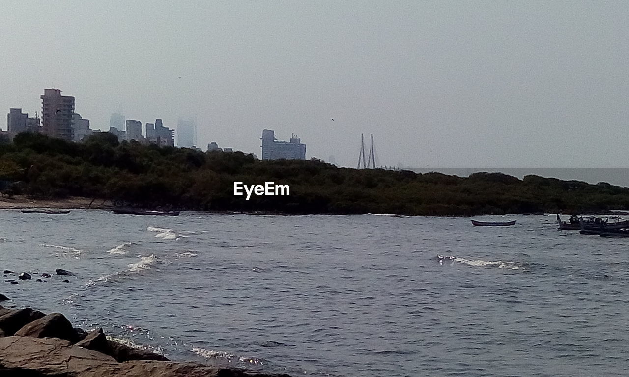 VIEW OF RIVER WITH BUILDINGS IN BACKGROUND