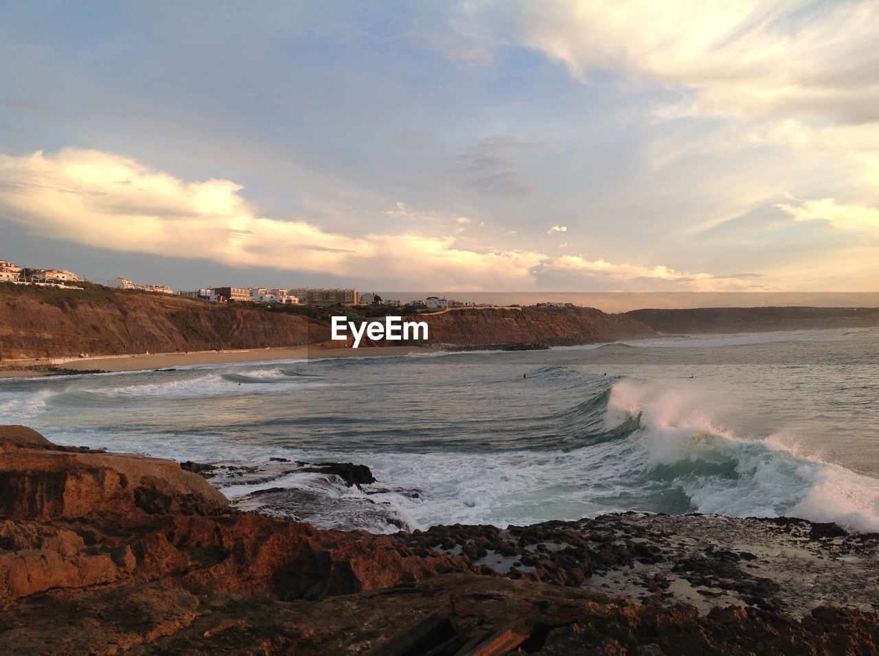 Scenic view of beach against sky during sunset