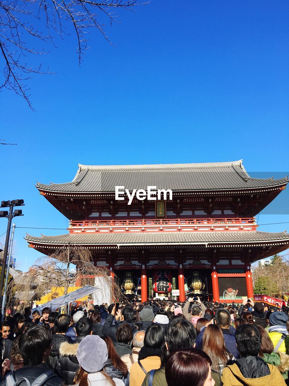 PEOPLE AT TEMPLE AGAINST CLEAR BLUE SKY