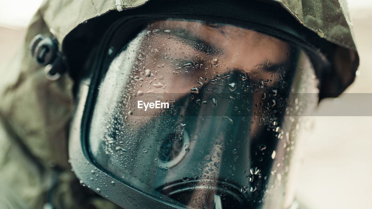 Man with gas mask under the rain