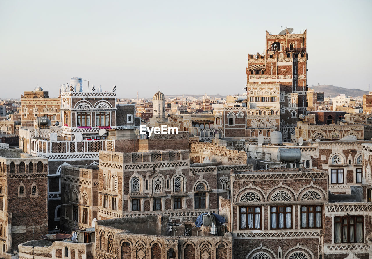 Old buildings in city against sky