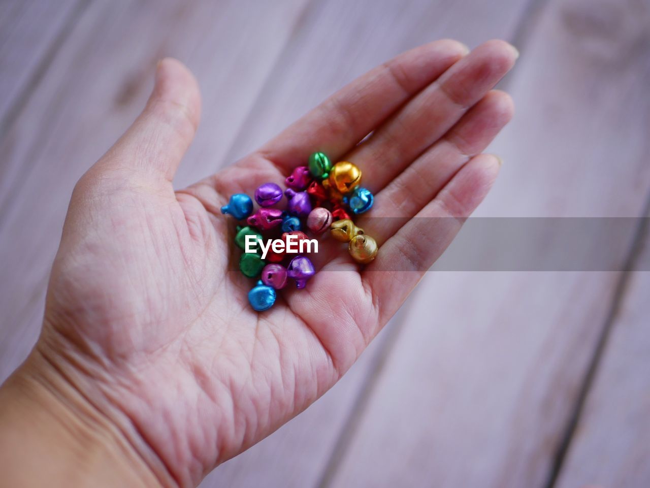 hand, pill, dose, medicine, finger, capsule, nail, one person, healthcare and medicine, holding, close-up, bead, jewellery, multi colored, large group of objects, nutritional supplement, indoors, variation, adult, blue, vitamin, high angle view