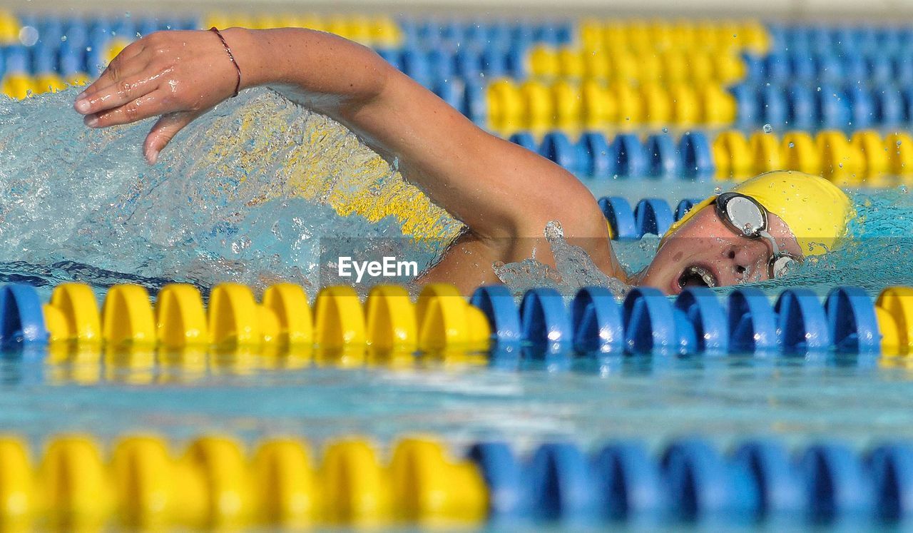 CLOSE-UP OF SWIMMING IN POOL