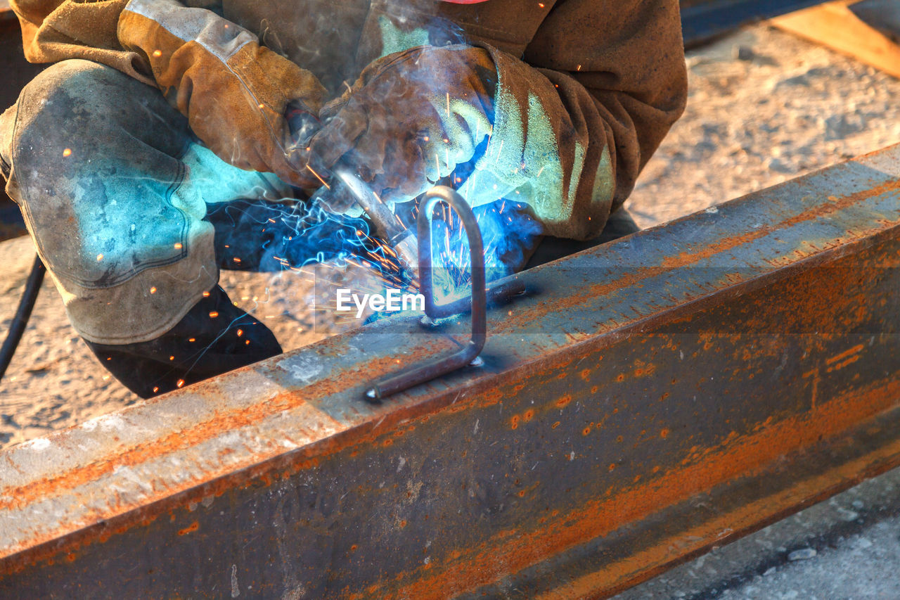 Welder welding at construction site