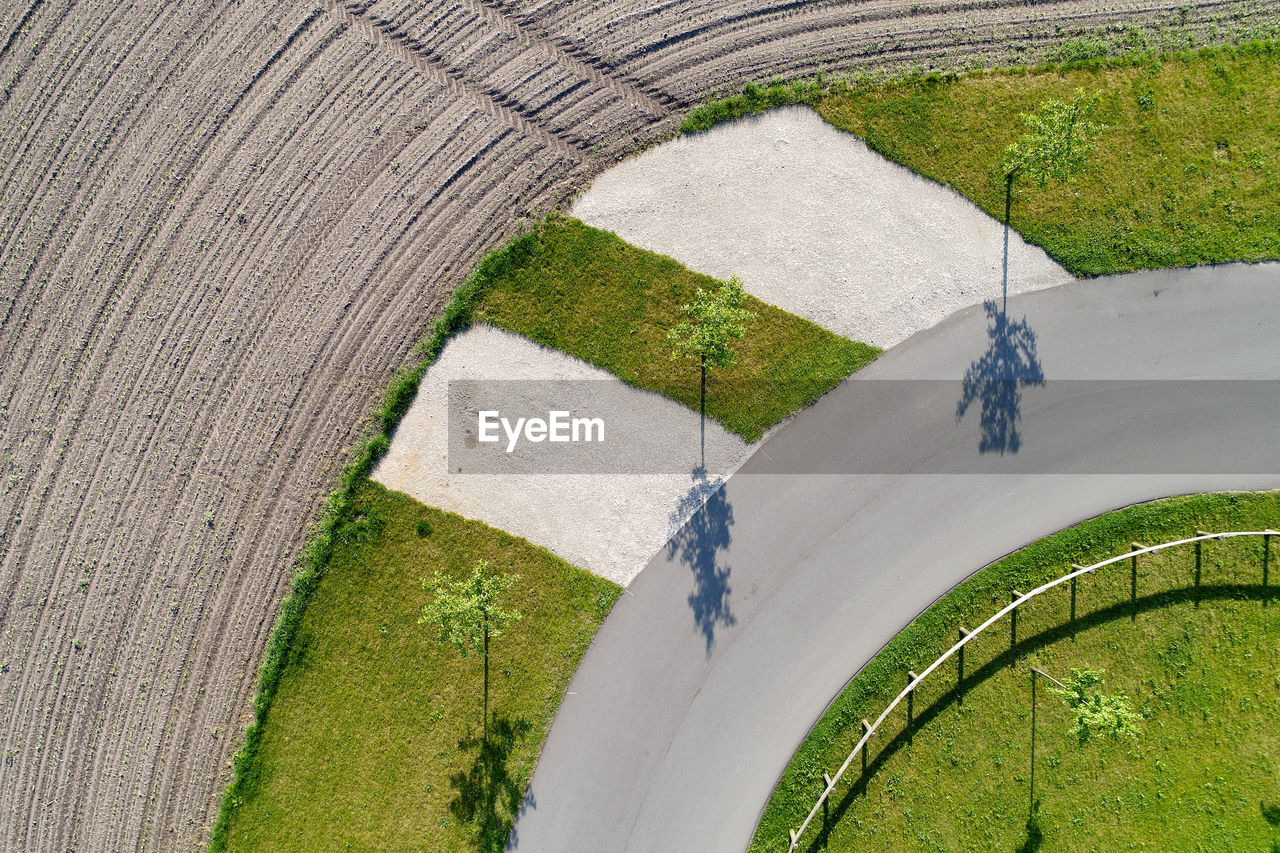 Aerial view of road amidst field