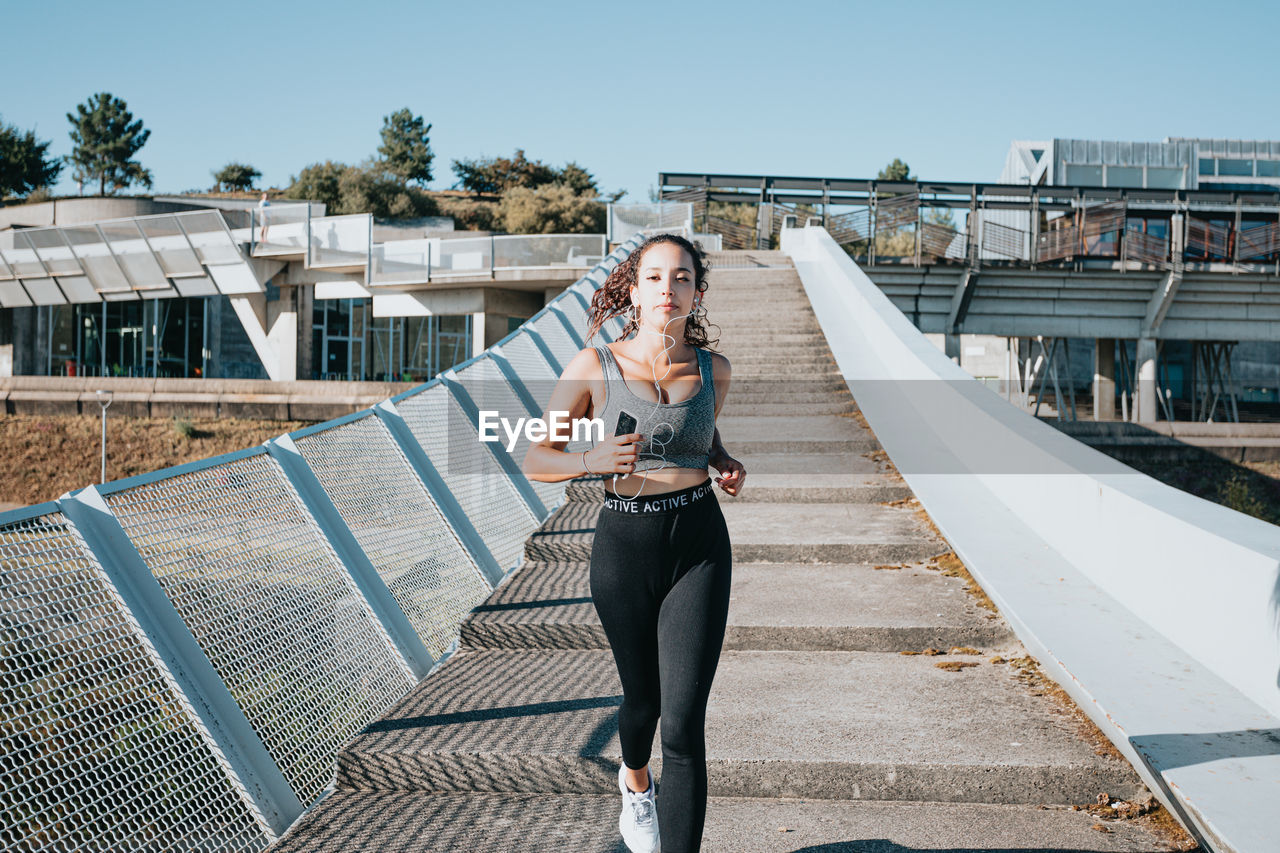 Female athlete running on steps