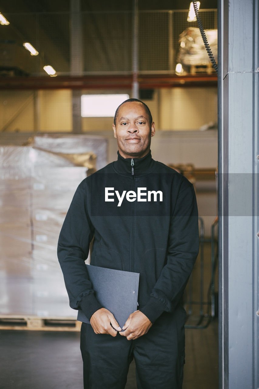 Portrait of smiling male manual worker at warehouse