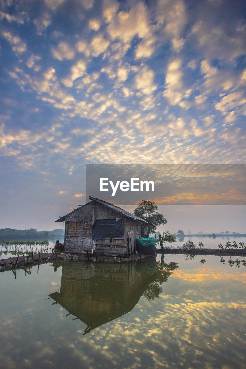 Scenic view of lake against sky at sunset